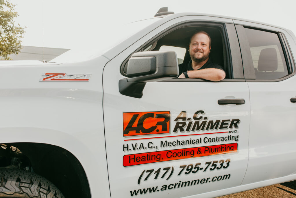 HVAC, Heating, Cooling, Plumbing, Duct Cleaning, Commercial & Residential Maintenance worker sitting in his truck smiling at camera